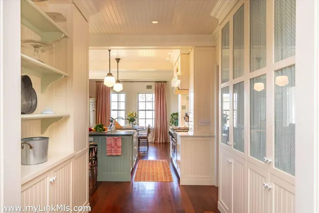 a kitchen with granite countertop a sink a counter top space and living room view