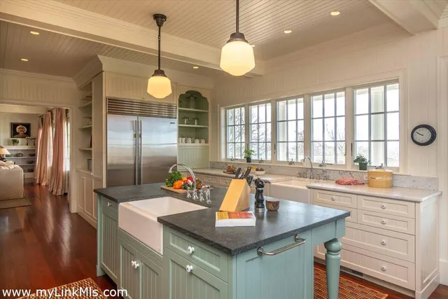 a bathroom with a granite countertop sink and large window