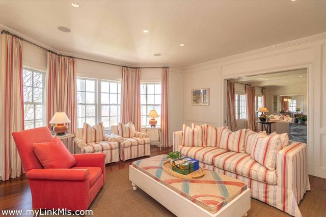 a bathroom with a granite countertop sink mirror and toilet