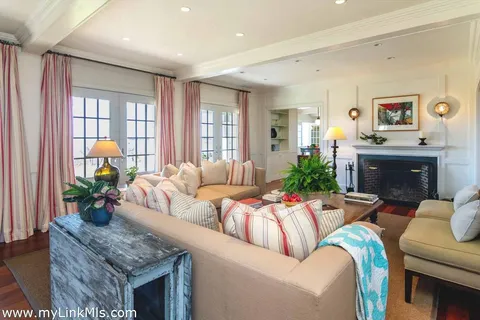 a living room with furniture a rug and a flat screen tv