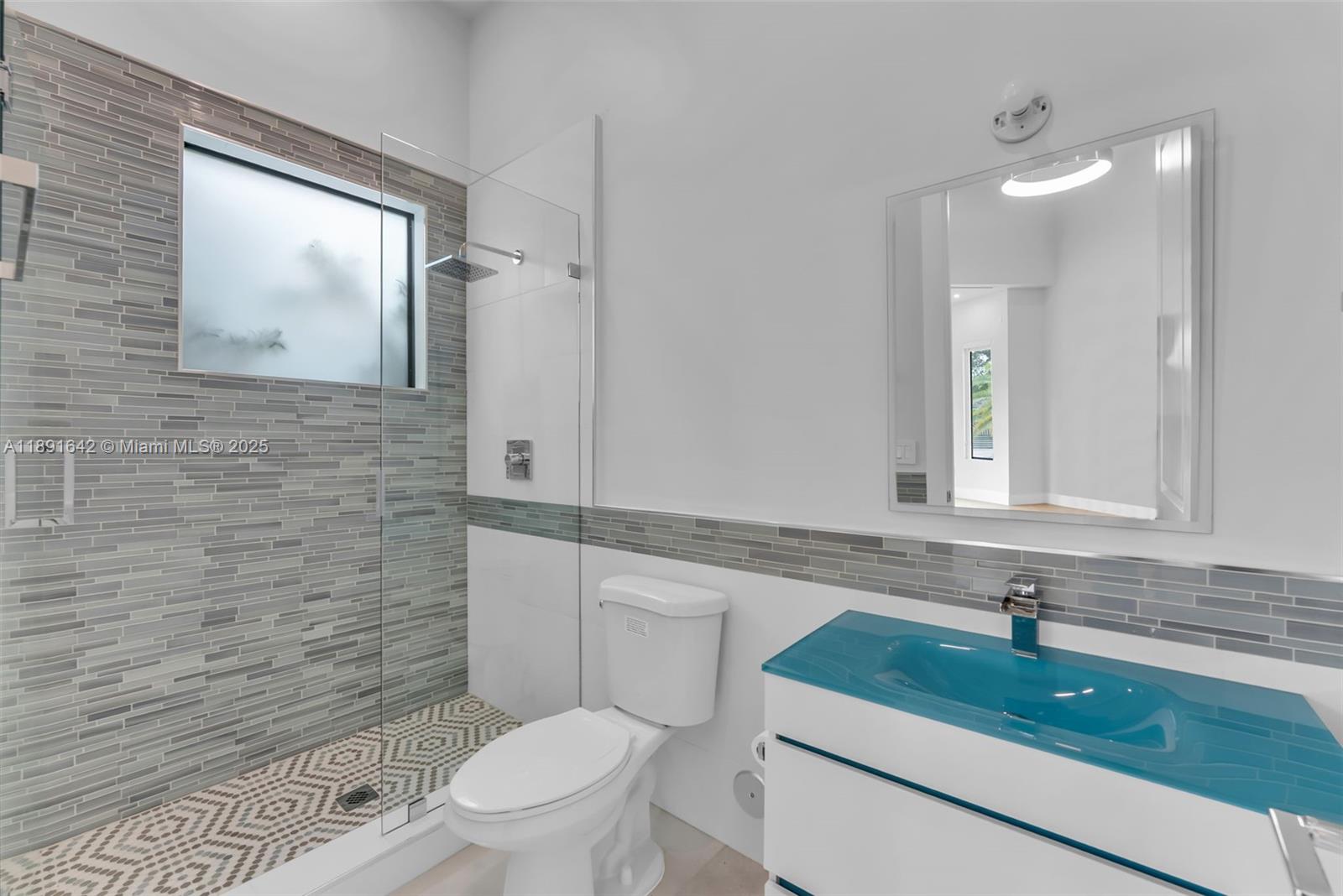 12175 Southwest 45th Street Miami, FL 33175 - Photo 14 of 58 a bathroom with a sink a toilet and shower