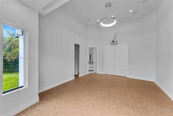 a spacious bedroom with a bed and a couch