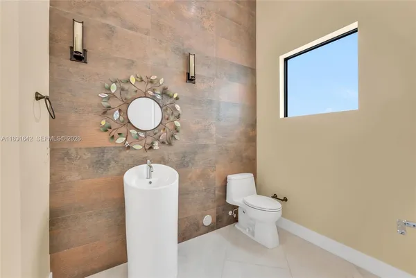 a spacious bedroom with a bed and a lamp