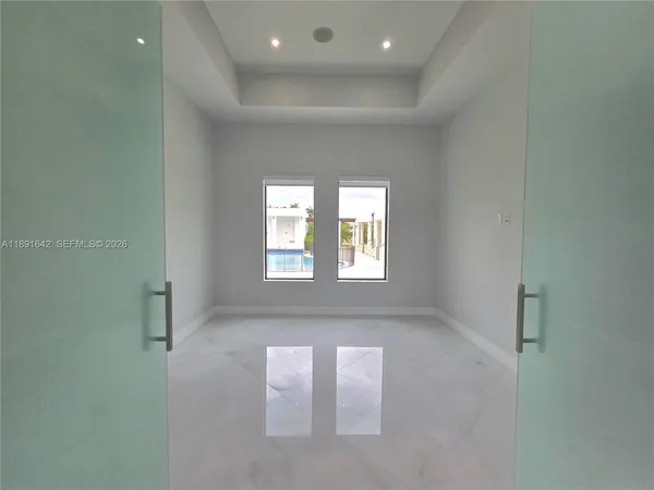 a white toilet sitting next to a white cabinet