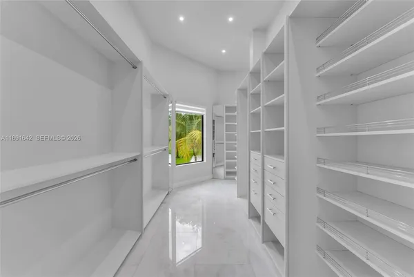 a view of an empty room with a fireplace and a large window