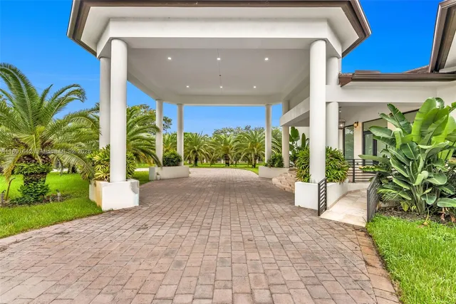 a view of a building stairs and a yard