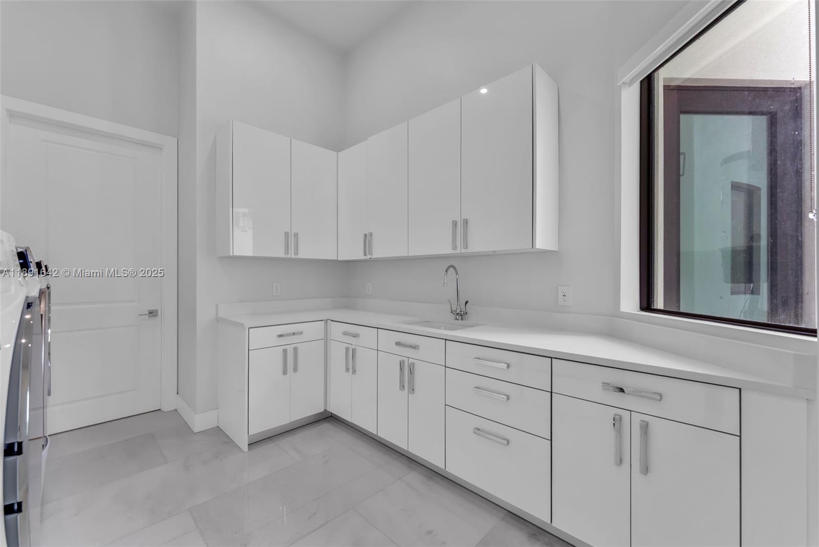 12175 Southwest 45th Street Miami, FL 33175 - Photo 33 of 58 a kitchen with white cabinets