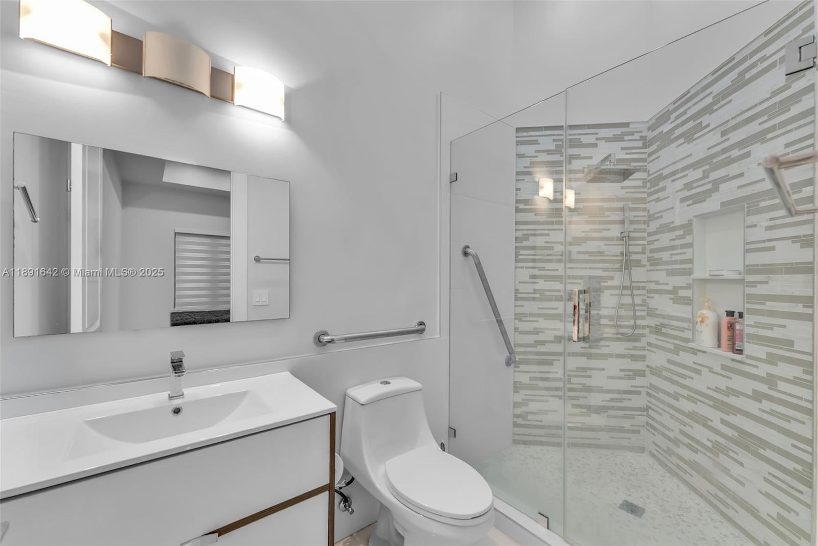 12175 Southwest 45th Street Miami, FL 33175 - Photo 37 of 58 a bathroom with a sink a toilet and shower