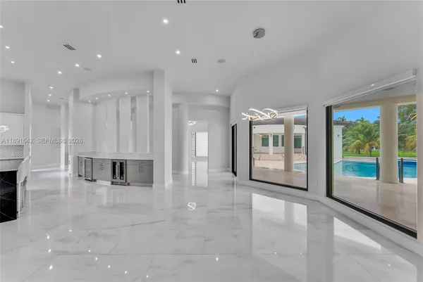 a view of an empty room with window and fireplace