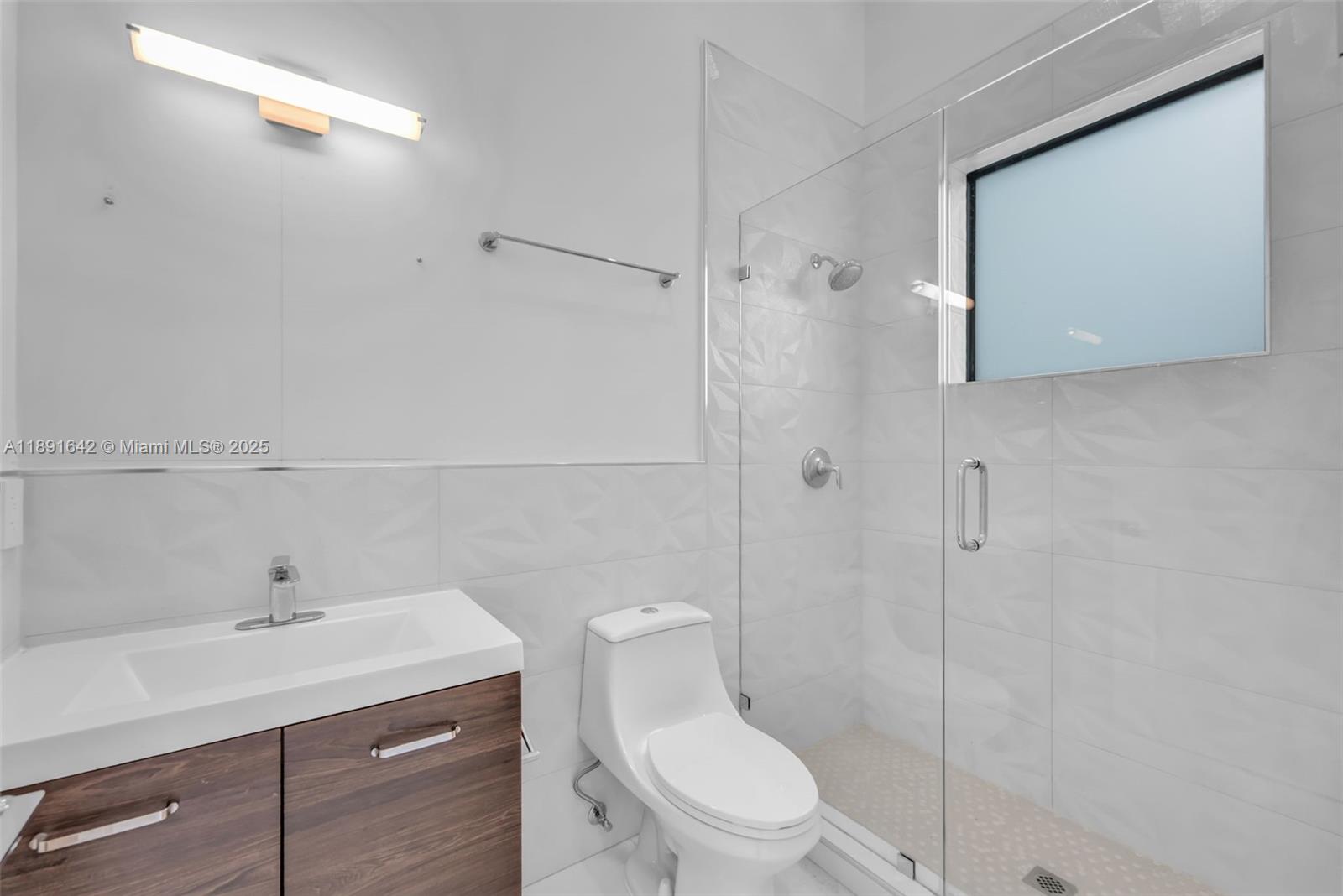 12175 Southwest 45th Street Miami, FL 33175 - Photo 39 of 58 a bathroom with a sink a toilet and shower