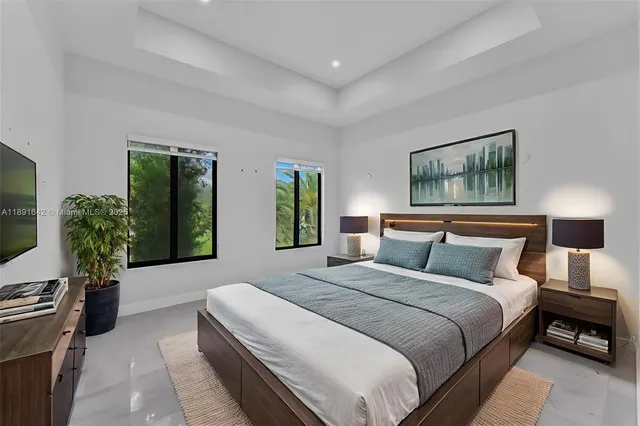 a room with a bed and a large window