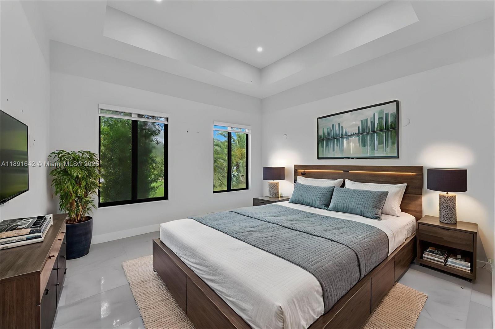 12175 Southwest 45th Street Miami, FL 33175 - Photo 41 of 58 a bedroom with bed a couch and a flat tv screen on dresser