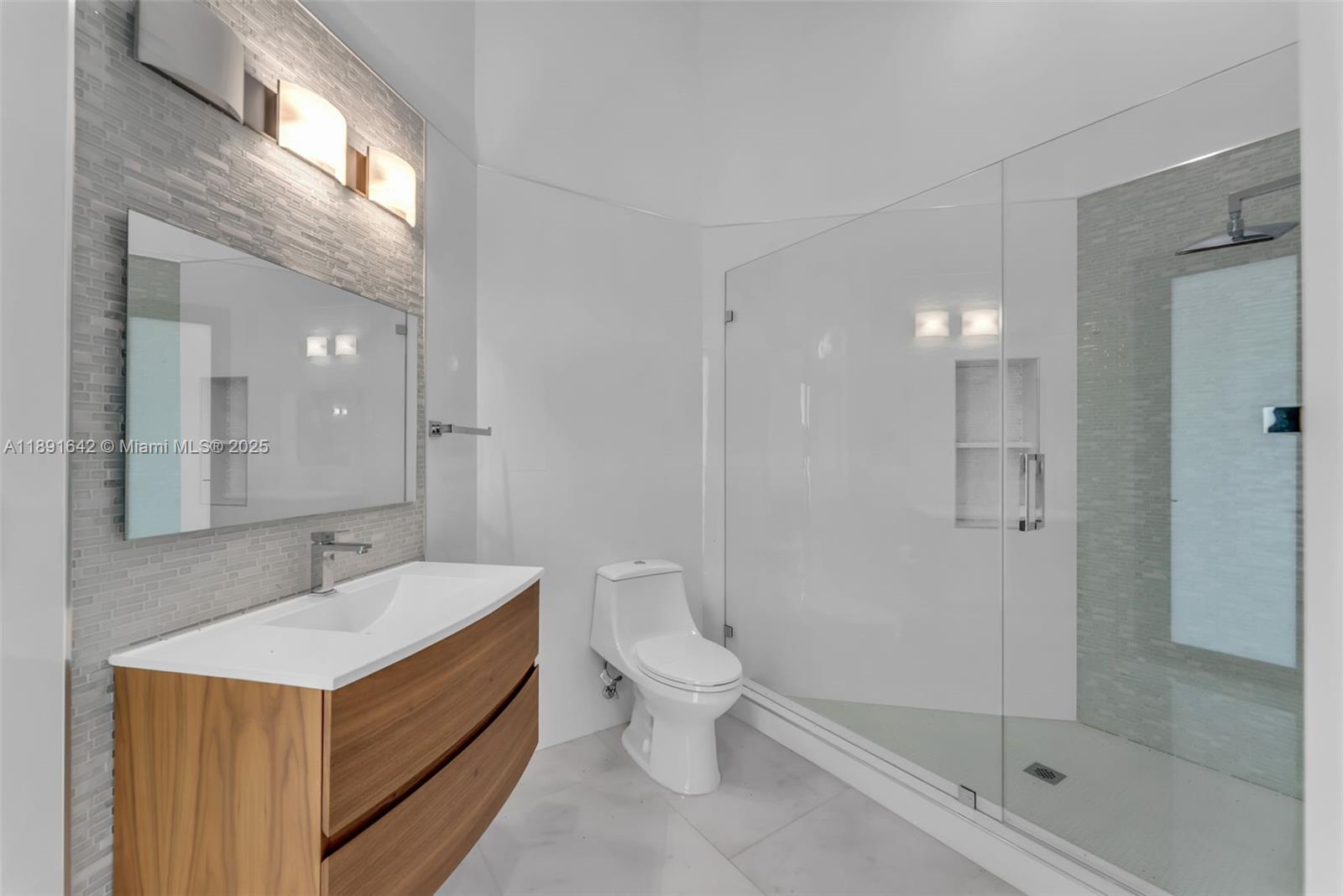 12175 Southwest 45th Street Miami, FL 33175 - Photo 44 of 58 a bathroom with a sink a toilet and shower