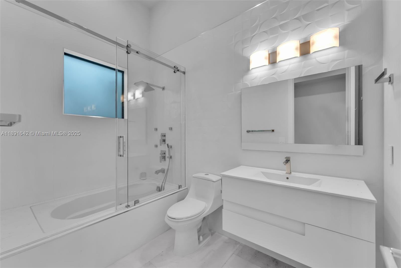 12175 Southwest 45th Street Miami, FL 33175 - Photo 45 of 58 a bathroom with a sink a toilet and shower