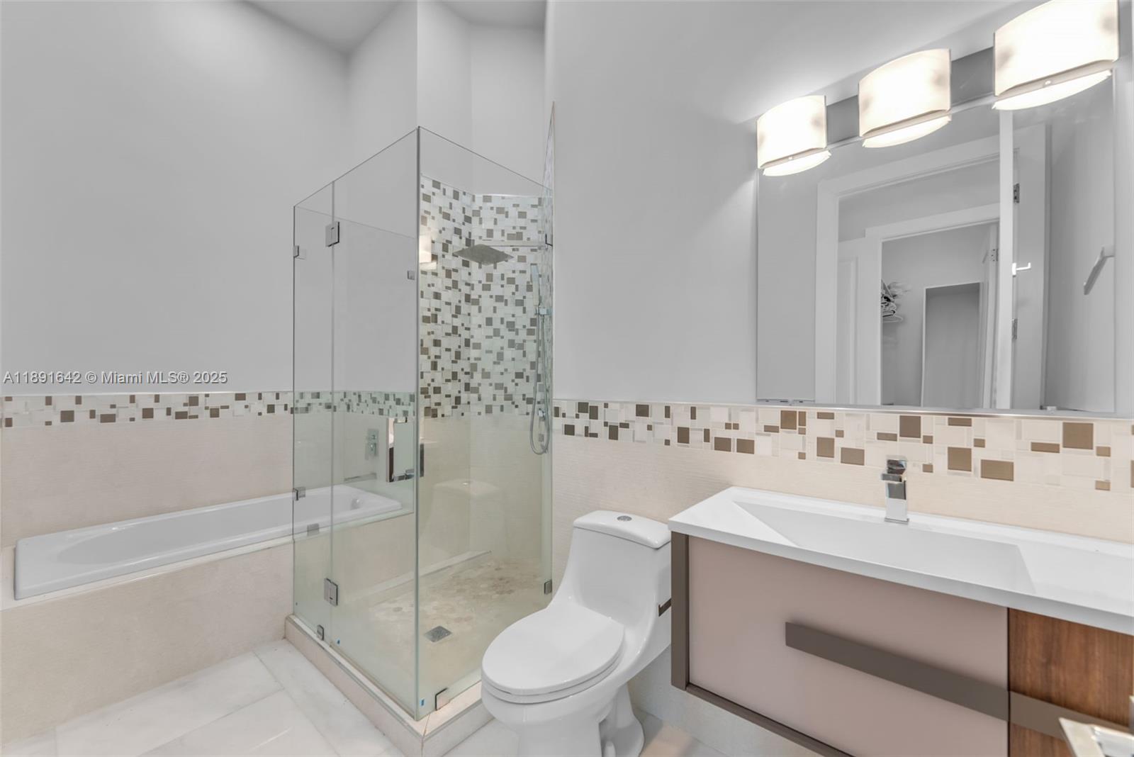 12175 Southwest 45th Street Miami, FL 33175 - Photo 47 of 58 a bathroom with a sink toilet vanity and shower