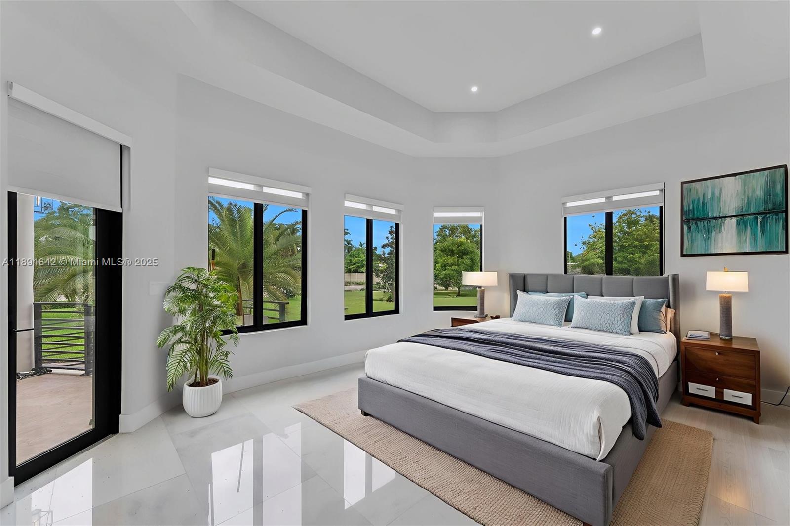 12175 Southwest 45th Street Miami, FL 33175 - Photo 49 of 58 a spacious bedroom with a balcony a large bed and a potted plant