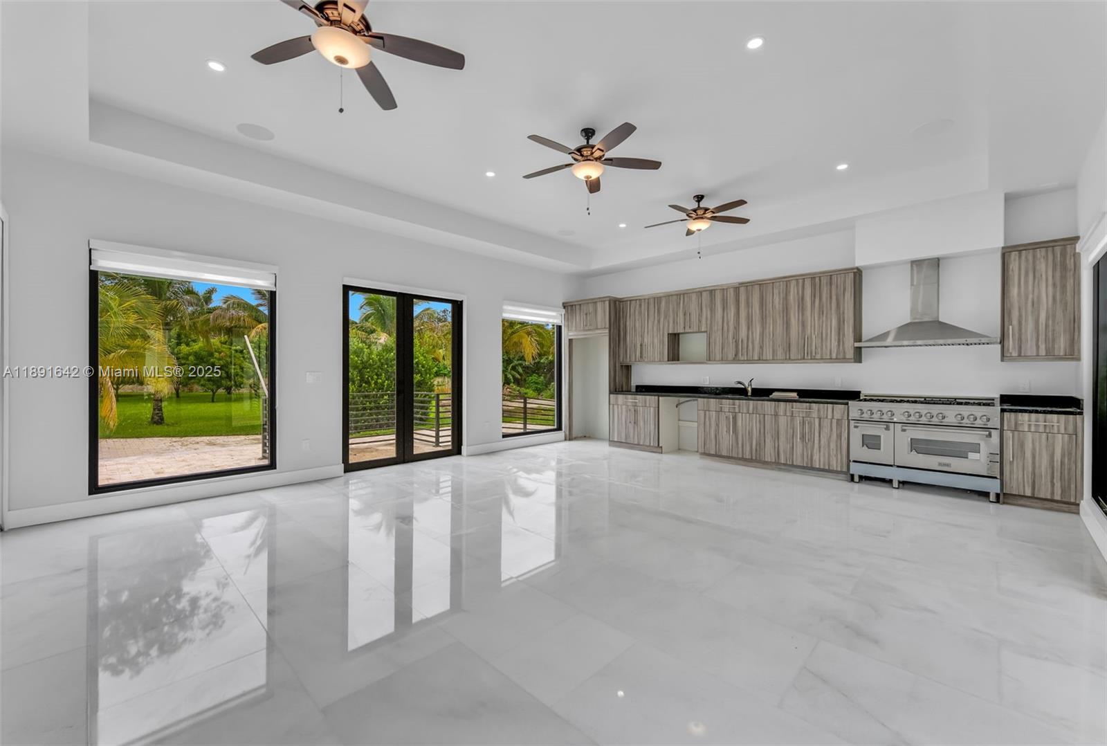 12175 Southwest 45th Street Miami, FL 33175 - Photo 54 of 58 a view of an empty room with a window and kitchen view