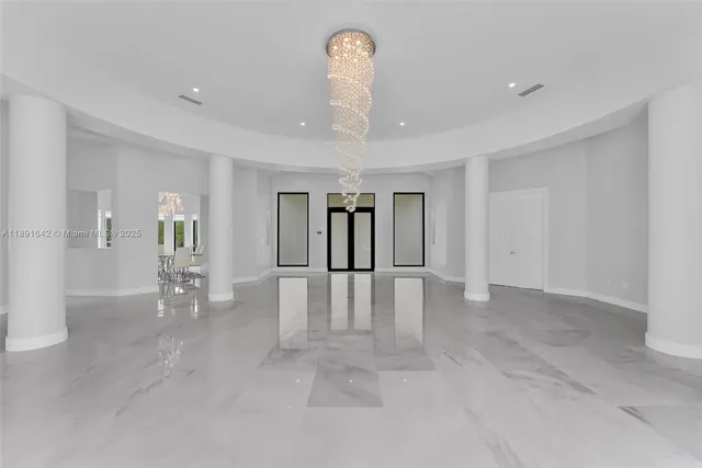 a living room with furniture potted plant and a large window