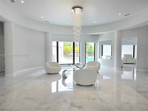 a view of a livingroom with furniture and a chandelier