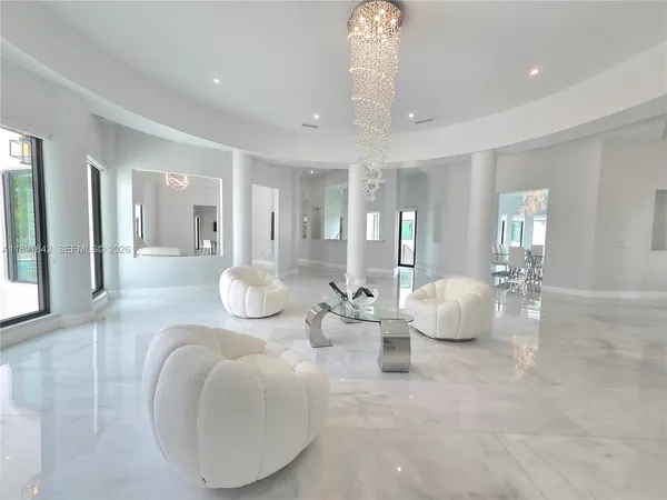 a view of a hallway with wooden floor and a bathroom