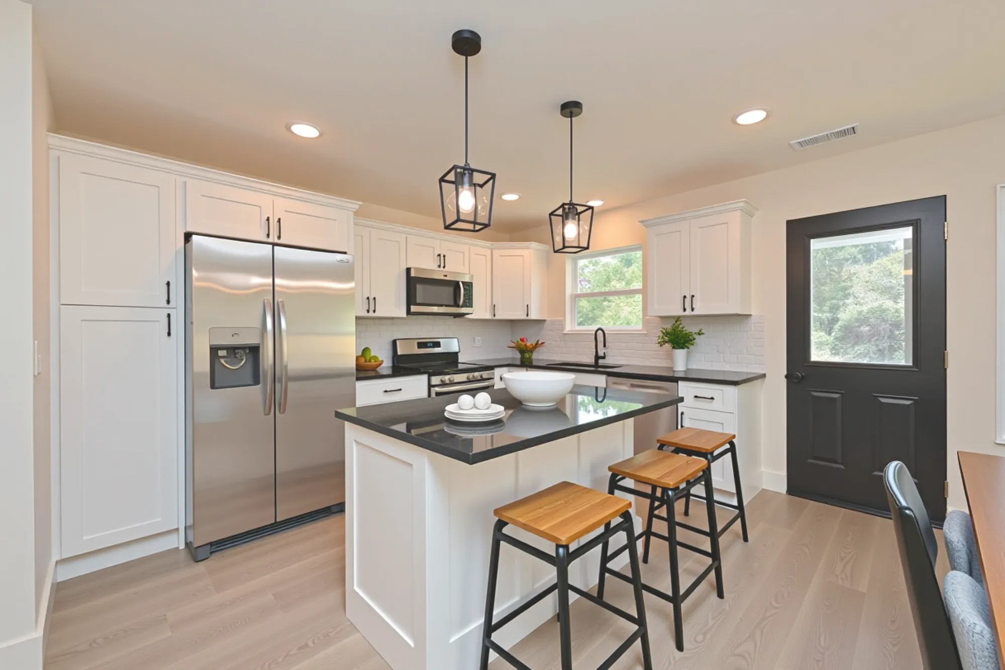 1613 Elizabeth Road Nashville, TN 37218 - Photo 4 of 14 a kitchen with stainless steel appliances granite countertop a refrigerator a sink a stove a dining table and chairs