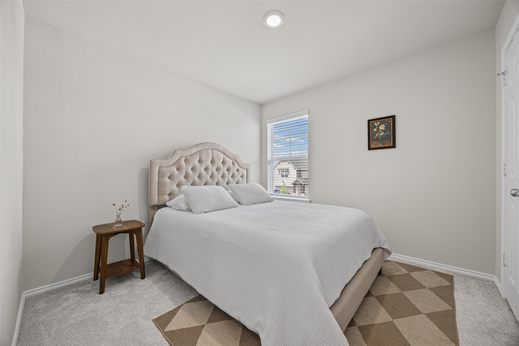 208 Orange Road Buda, TX 78610 - Photo 19 of 31 A tranquil bedroom provides comfort with soft carpeting and a window offering natural light.