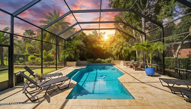 a view of a swimming pool with a patio and a yard