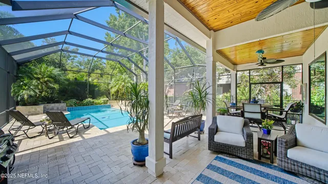 a view of a white house with a yard and plants