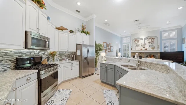 a kitchen with granite countertop a sink stove and cabinets