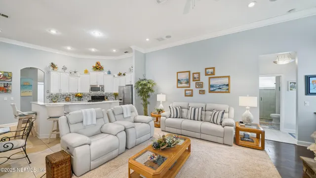 a spacious bathroom with a double vanity sink a large mirror a bathtub and shower