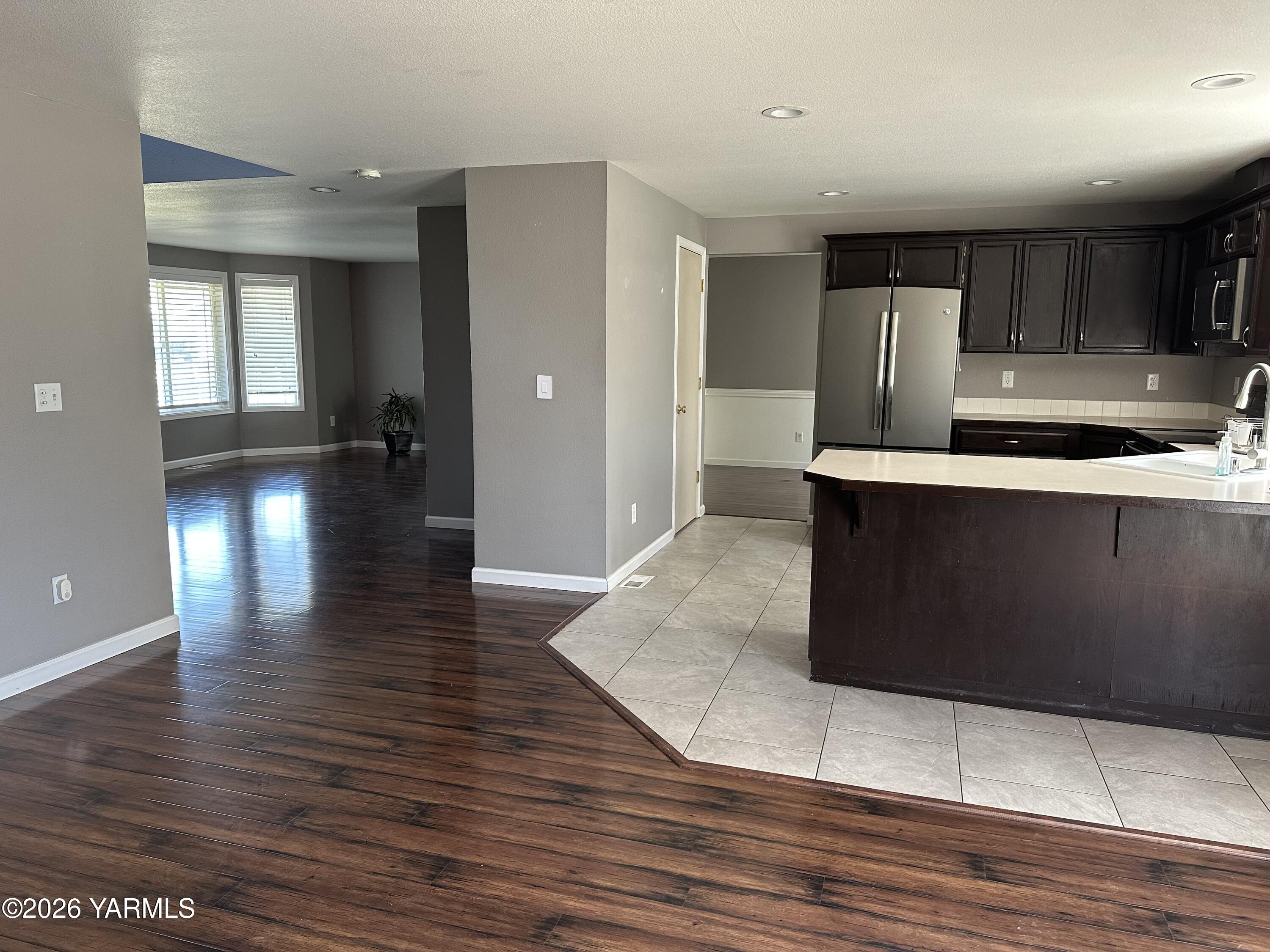 514 Cascade Avenue Moxee, WA 98936 - Photo 25 of 25 a kitchen with stainless steel appliances granite countertop a sink a stove and a wooden floors