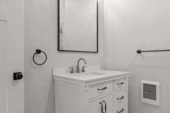843 Main Street, Unit 104 Clinton, MA 01510 - Photo 13 of 19 a bathroom with a sink vanity and a mirror