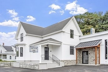 843 Main Street, Unit 104 Clinton, MA 01510 - Photo 2 of 19 a view of a white house with a chandelier
