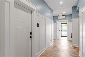 843 Main Street, Unit 104 Clinton, MA 01510 - Photo 3 of 19 a view of a hallway with wooden floor