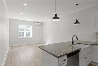 a kitchen with a sink a counter space and a window