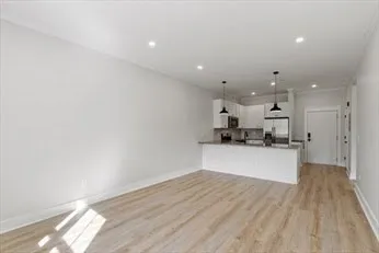 a kitchen with a refrigerator and a counter top space