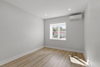 843 Main Street, Unit 104 Clinton, MA 01510 - Photo 9 of 19 an empty room with wooden floor and windows