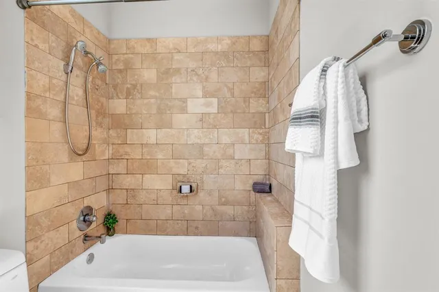 a bedroom with a bed lamp and a large window