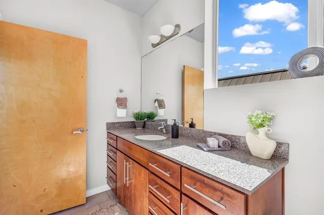 a bathroom with a granite countertop sink toilet and shower