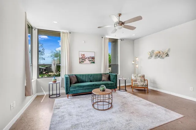 a living room with furniture and a large window