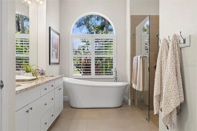 a bathroom with a bathtub sink and mirror