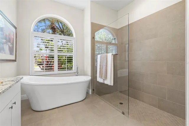 a bathroom with a bathtub and window