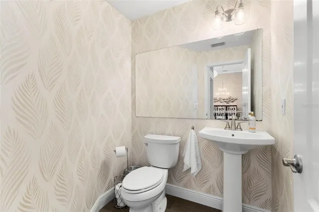 a bathroom with a sink toilet and a mirror