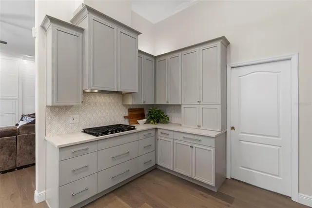 a kitchen with white cabinets and white appliances