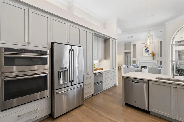 a kitchen with a sink stainless steel appliances and cabinets