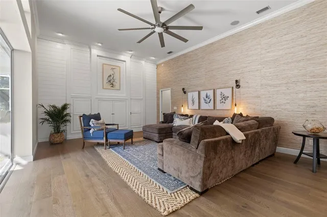 a living room with furniture and a wooden floor
