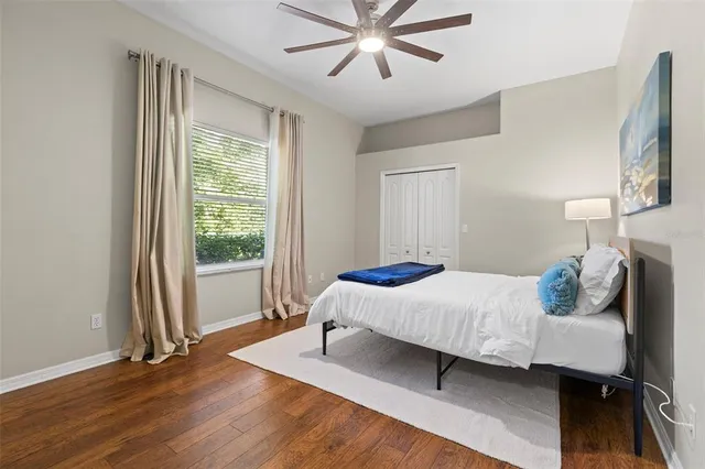 a bedroom with a bed and wooden floor
