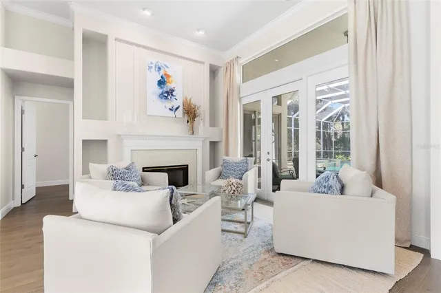 a living room with furniture a fireplace and a large mirror