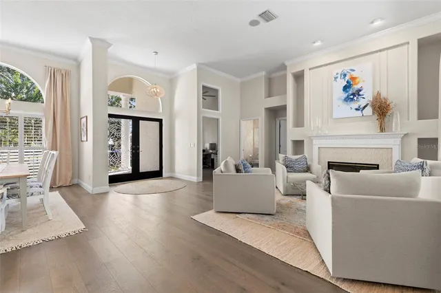 a living room with fireplace furniture and a window