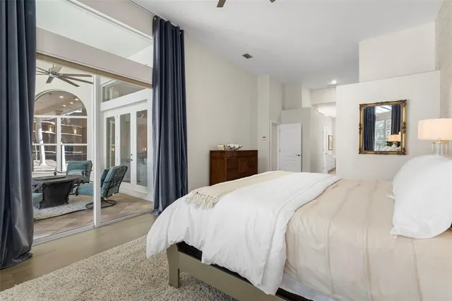 a bedroom with a large bed and a large window